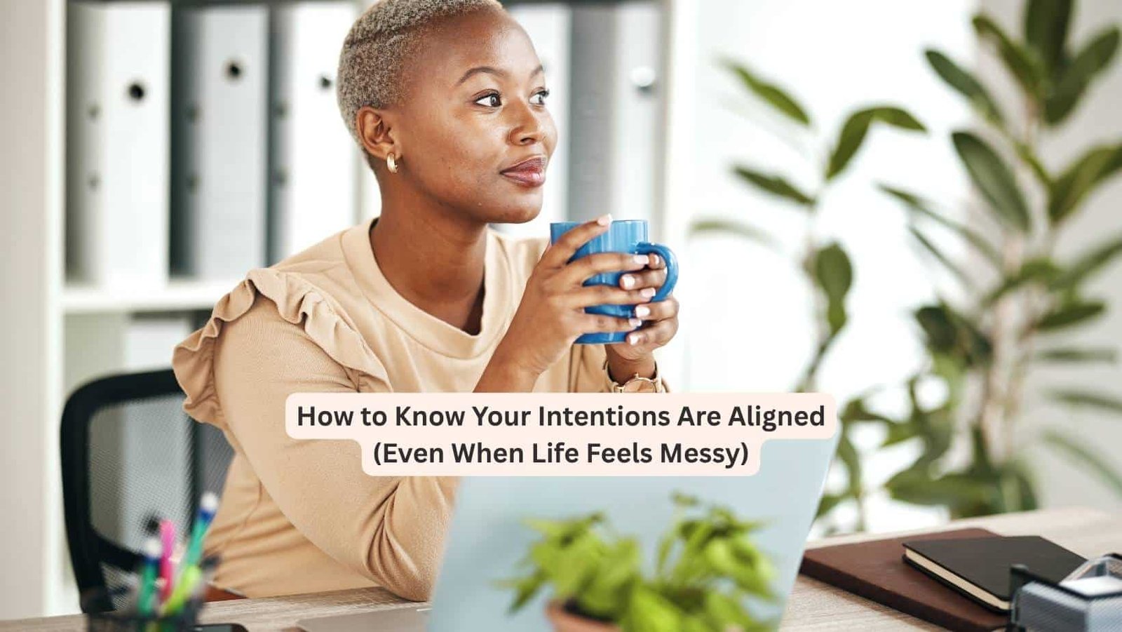 Black woman sitting in her office with a cup of coffee. How to know when your intentions are aligned.